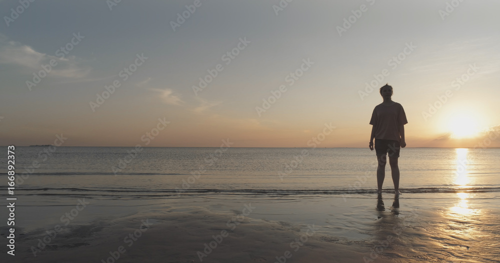 teen girl barefoot stand in water on baltic sea beach in sunset time teen girl barefoot stand in water on baltic sea beach in sunset time