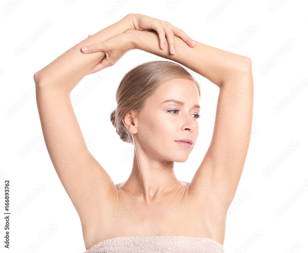Beautiful young woman in towel on white background. Concept of using deodorant Beautiful young woman in towel on white background. Concept of using deodorant