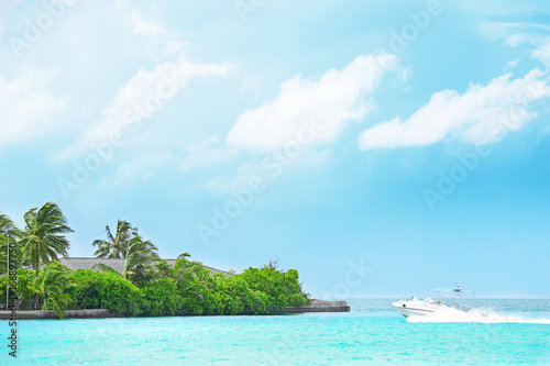 Beautiful seascape with modern boat and tropical island