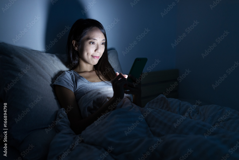 Woman sending sms on mobile phone