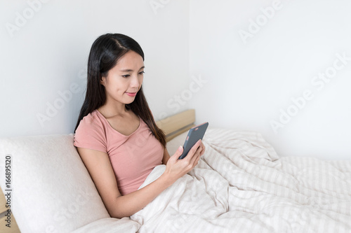 Woman use of smart phone on bed