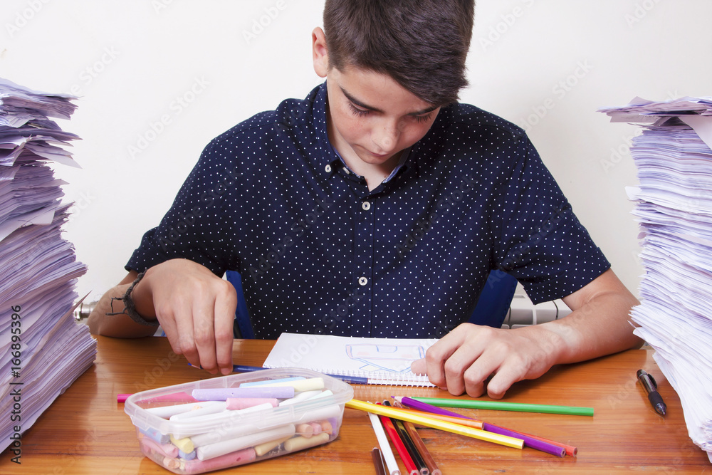child studying on the desktop with stacked papers child studying on the desktop with stacked papers
