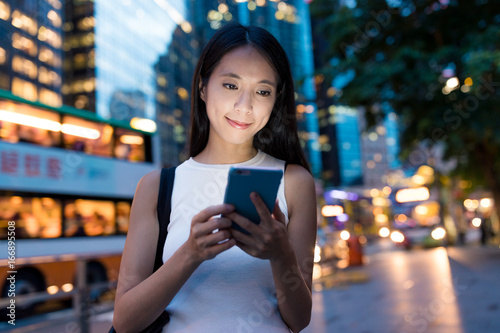 Woman using smart phone in evening