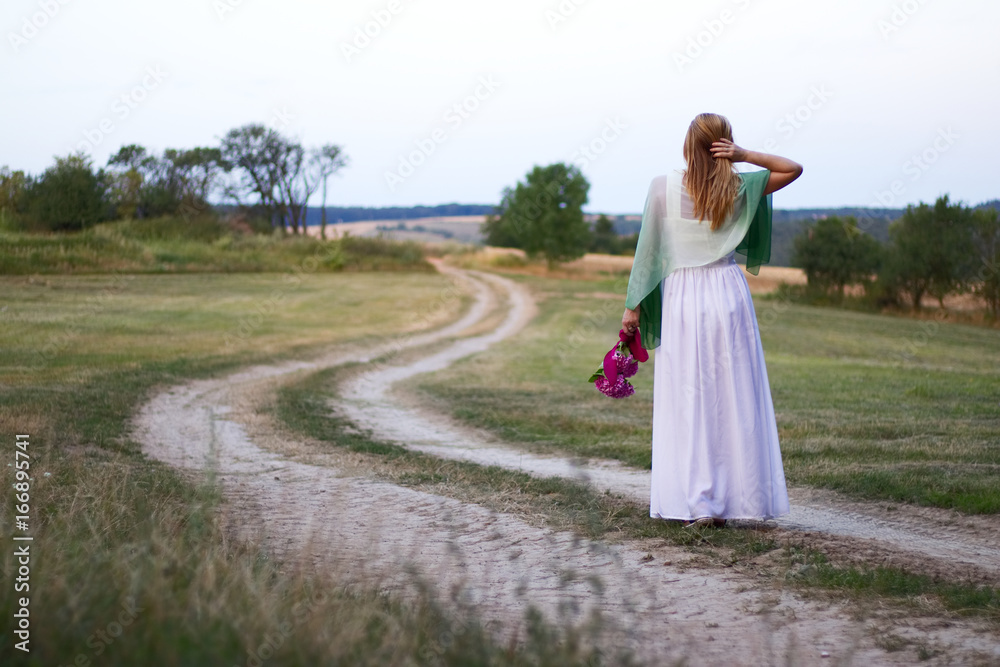 The beautiful bride on a rural footpath The beautiful bride on a rural footpath