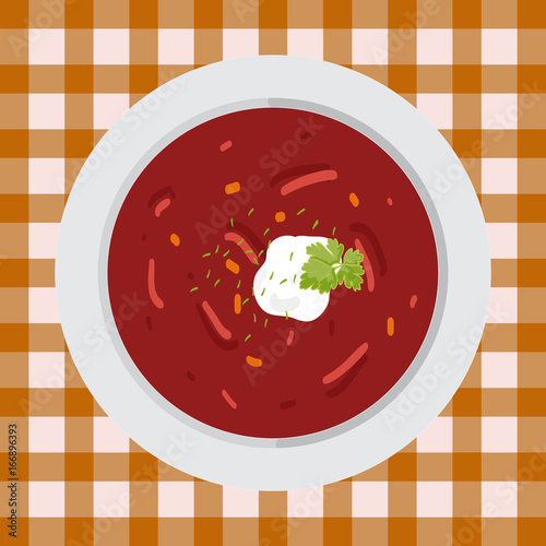 Soup borsch with parsley and sour cream on the plate on the table with a tablecloth