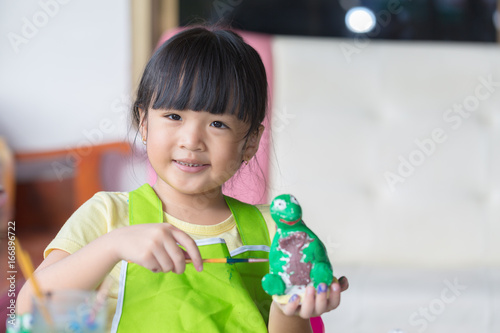 Asian girl painted on plaster doll
