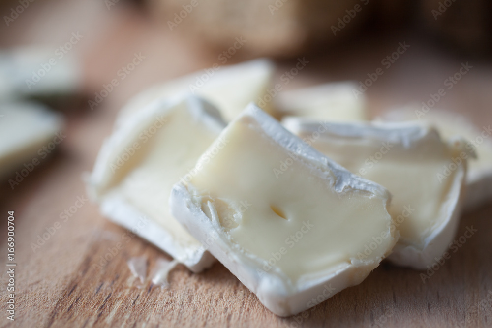 cheese brie lying on a wooden platter