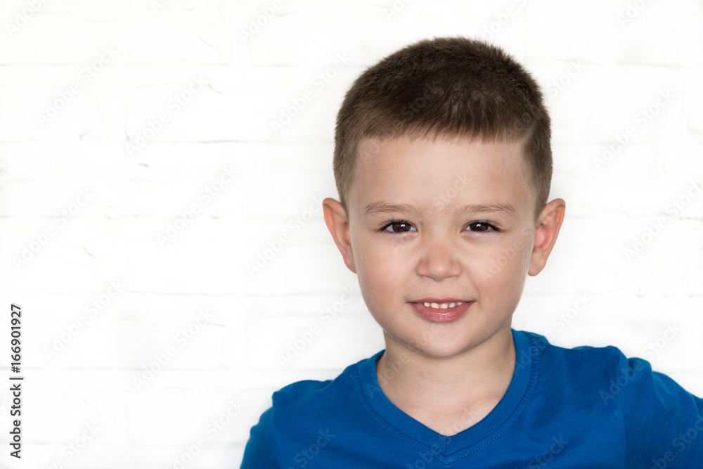 Young boy wearing blue jacket smiling while looking at camera. Young boy wearing blue jacket smiling while looking at camera.