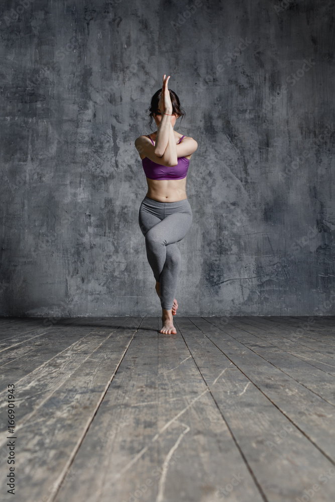 Fototapeta premium Young beautiful fitness female posing in studio