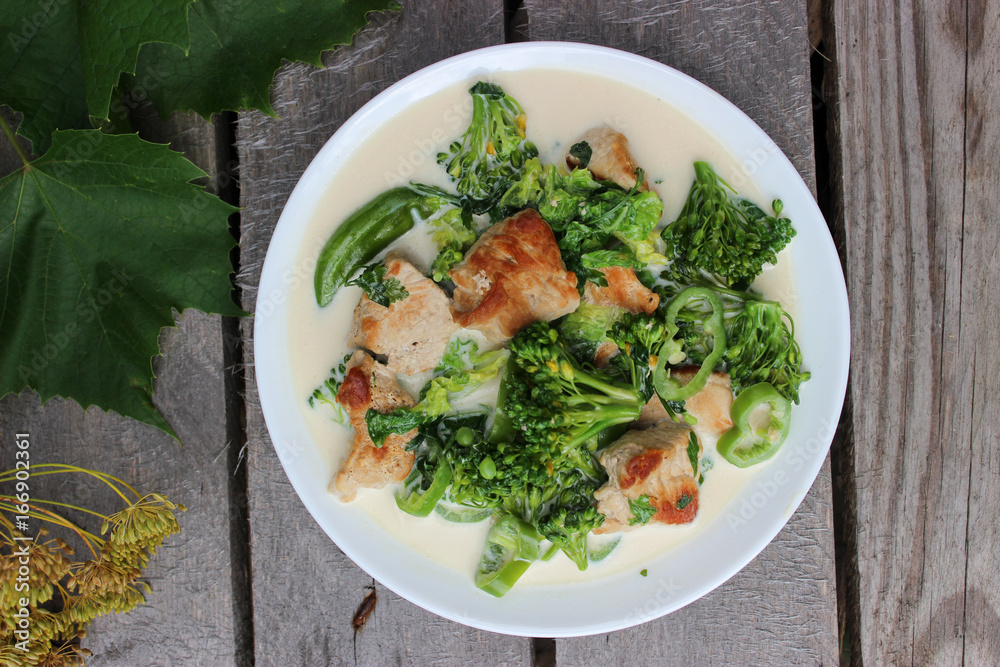 Nutritious dish of roasted pork fillet, green pepper, greens, broccoli in cream Nutritious dish of roasted pork fillet, green pepper, greens, broccoli in cream