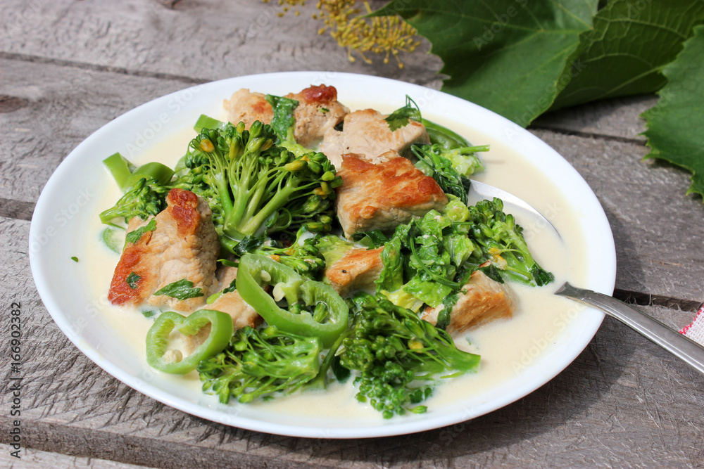 Nutritious dish of roasted pork fillet, green pepper, greens, broccoli in cream Nutritious dish of roasted pork fillet, green pepper, greens, broccoli in cream