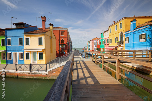 The colorful architecture of the sunny Island of Burano, a tourist attraction near Venice, Italy, which shows the harmony, joyful approach and lifestyle © Rochu_2008