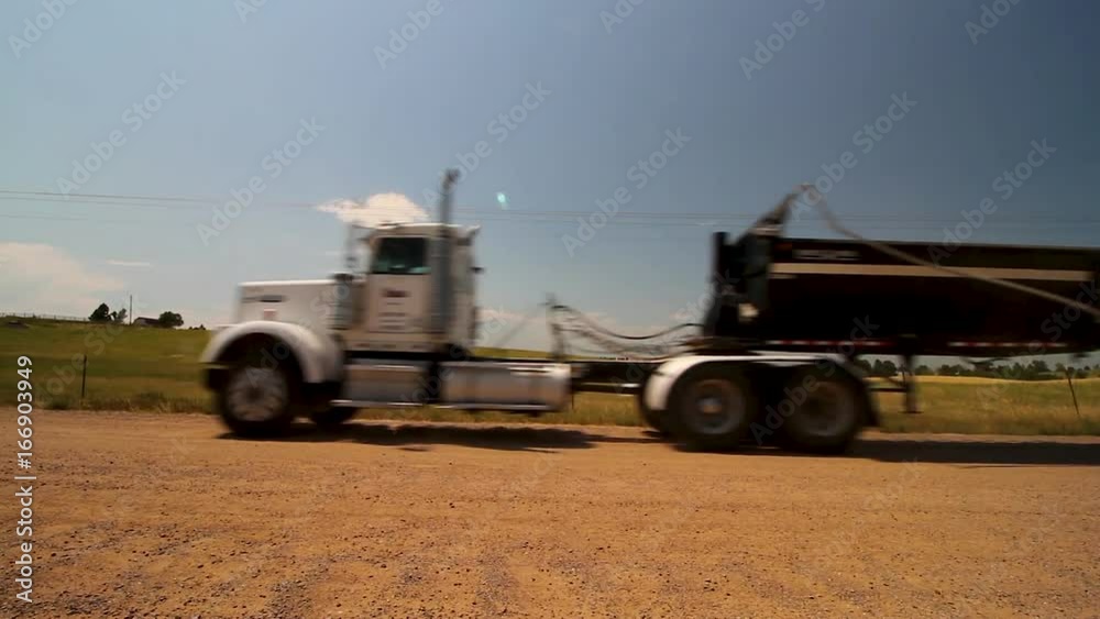 truck driving down a dirt road