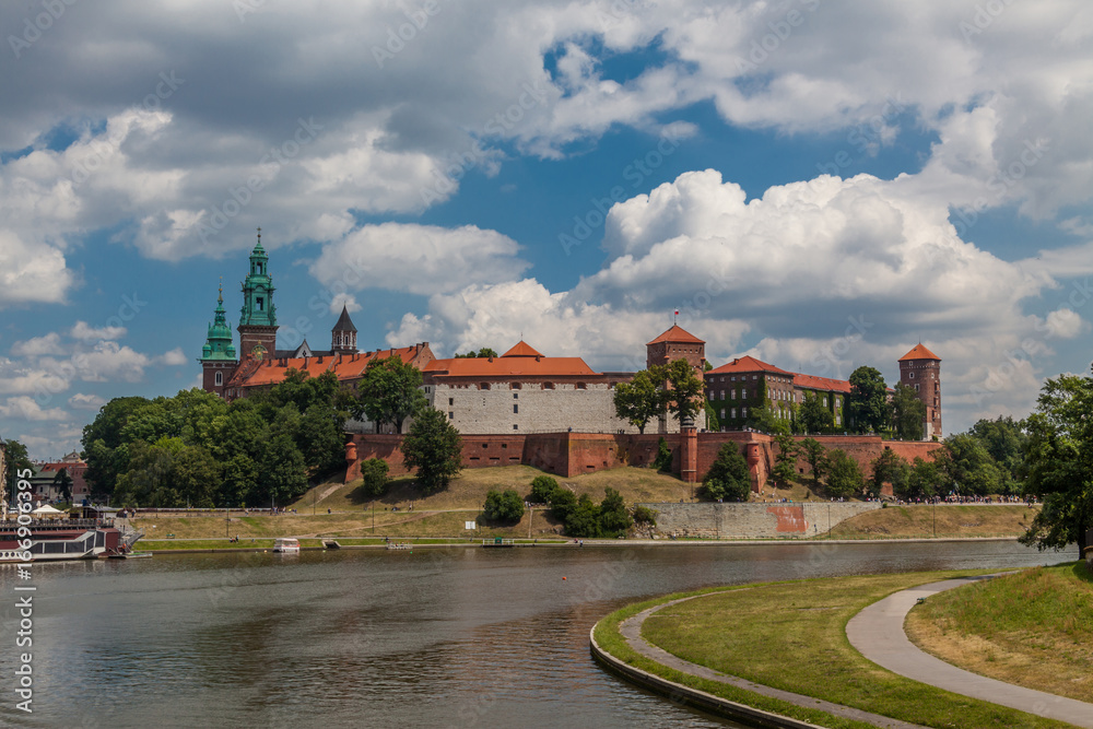 Fototapeta premium a view of fortification ion complex of Wawel Krakow with blue sky and river Wisla on the foreground