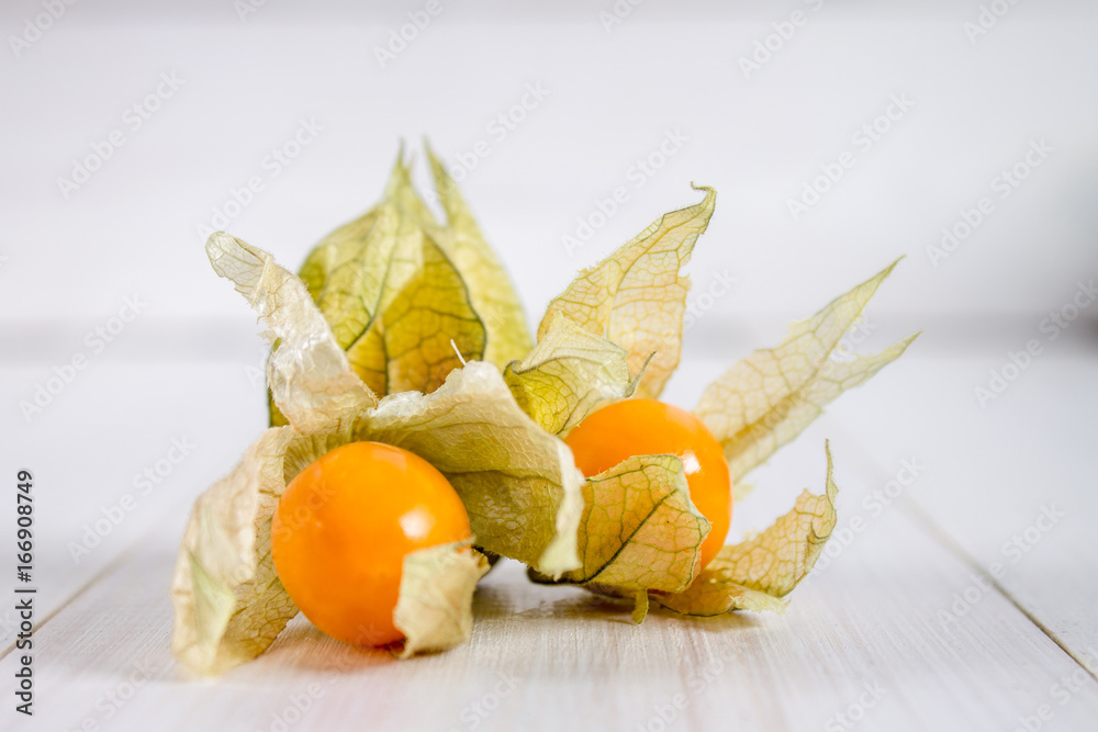 Exotic berries physalis on a white wooden table. Exotic berries physalis on a white wooden table.