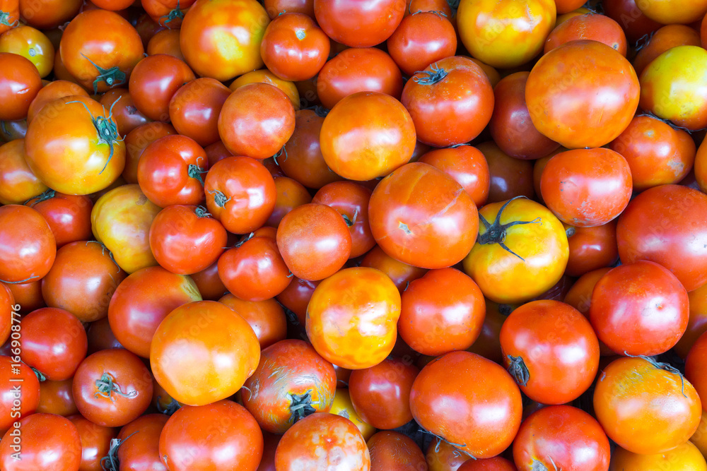 Close-up red tomatoes background. Group of tomatoes at market