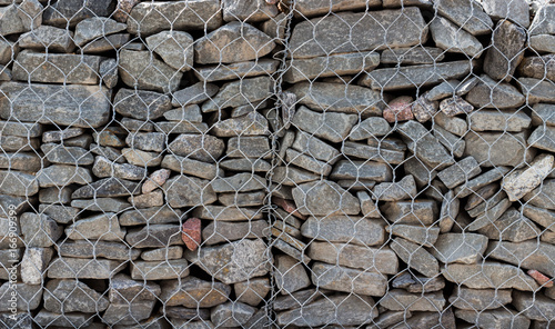 Wall of stones behind the grid