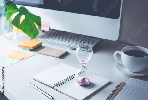 Billede på lærred hourglass with worktable office.Time,motivation concept