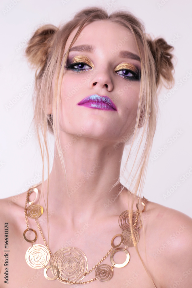 beautiful young girl with blond hair and bright makeup
