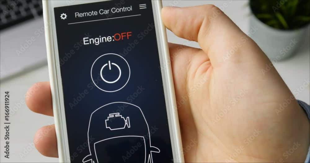Man remotely starts engine of his car. Car remote control using smartphone application fictional interface.