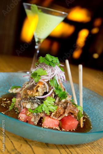 king crab tempura, served with red onion, watermelon, garnish and finished off with a drizzle of tangy amazu ponzu sauce photo