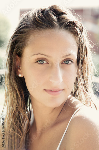 Portrait of cute blond girl with wet hair and blue eyes