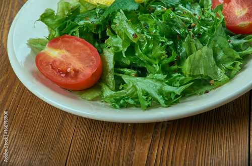 salad from leaves of wild radish photo