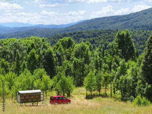 Mobile apiary trailer in meadow. View of Pljesevica mountain, Croatia.