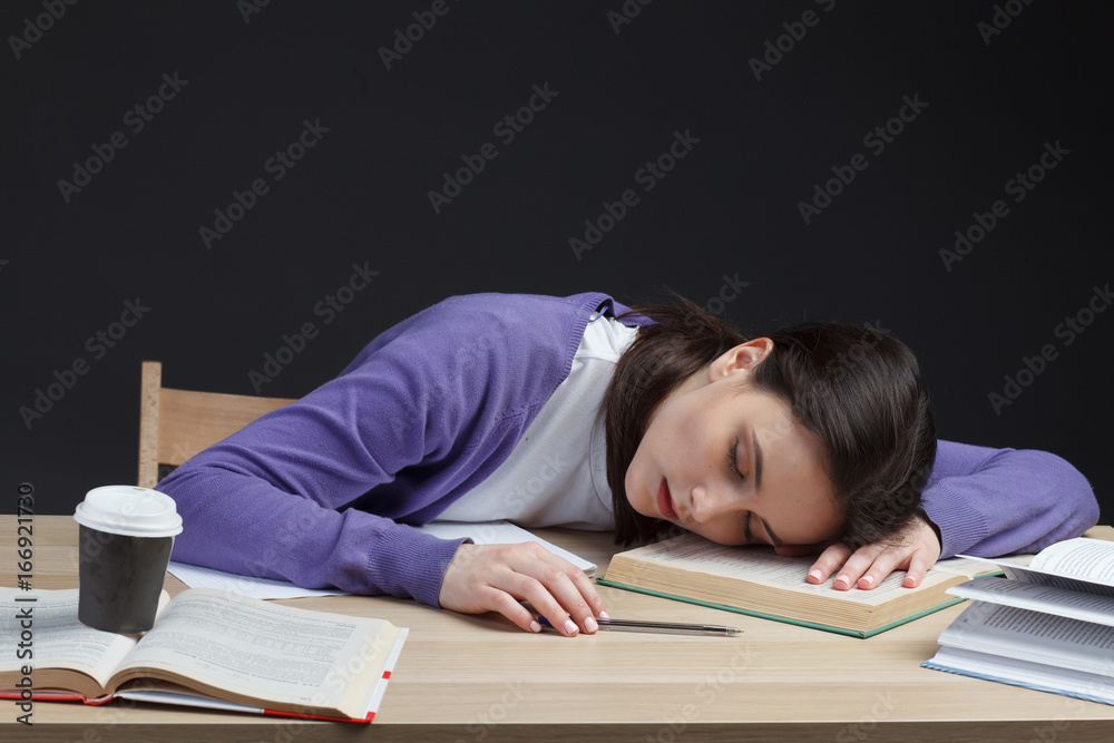 attractive student adult girl slipping on class desk on education books attractive student adult girl slipping on class desk on education books