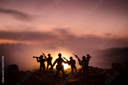 War Concept. Military silhouettes fighting scene on war fog sky background, World War Soldiers Silhouettes Below Cloudy Skyline At night. Attack scene. Armored vehicles. Tanks battle