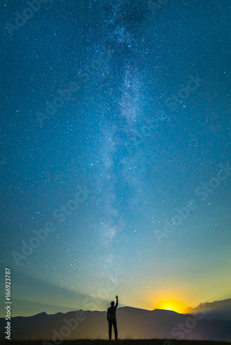 The man stand and gesture on the background of the milky way. night time © realstock1