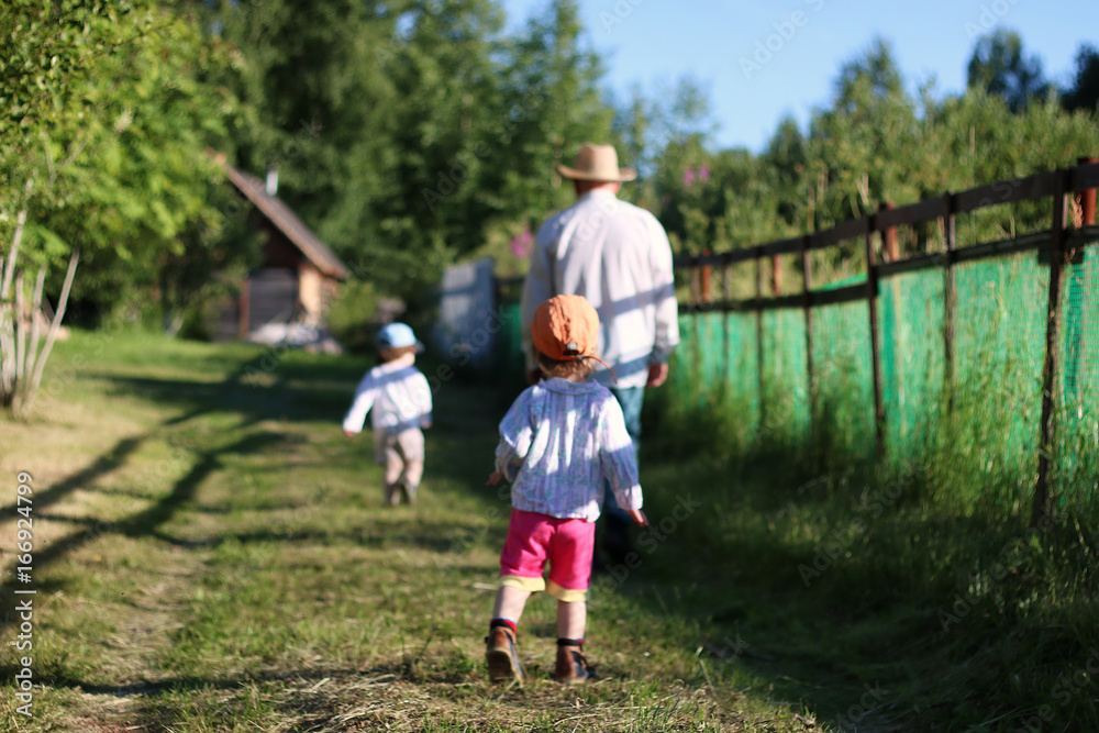 Fototapeta premium two kids walk grandfather