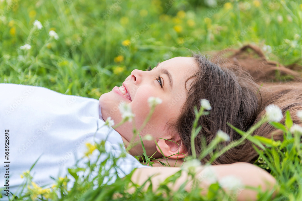 Cheerful female kid enjoying summer on field Cheerful female kid enjoying summer on field