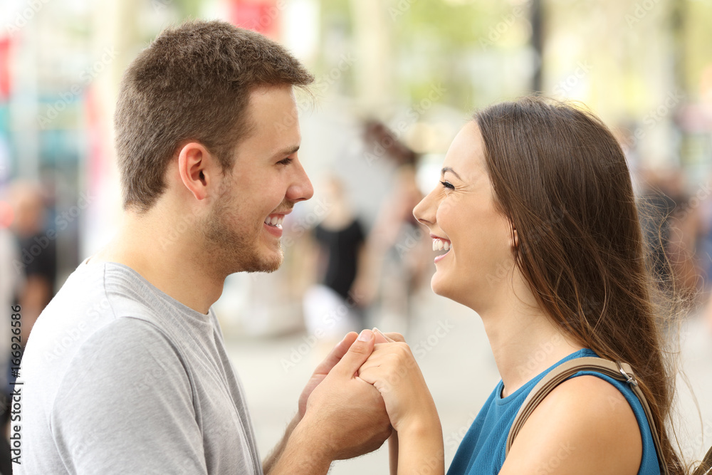 Couple in love holding hands on the street Couple in love holding hands on the street