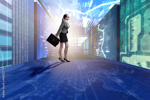 Businesswoman walking in data management concept © Elnur