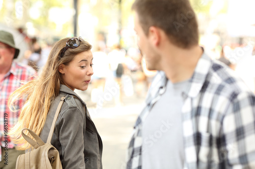 Sassy girl looking at man bottom on the street photo