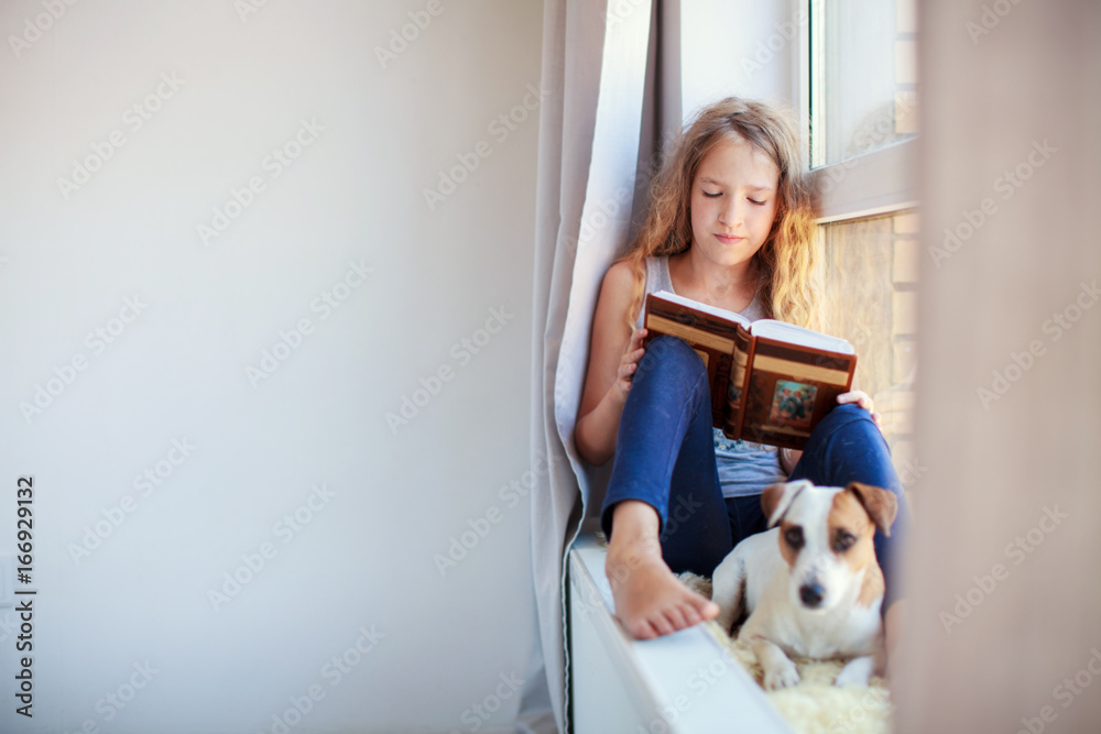 Girl reading book at home Girl reading book at home