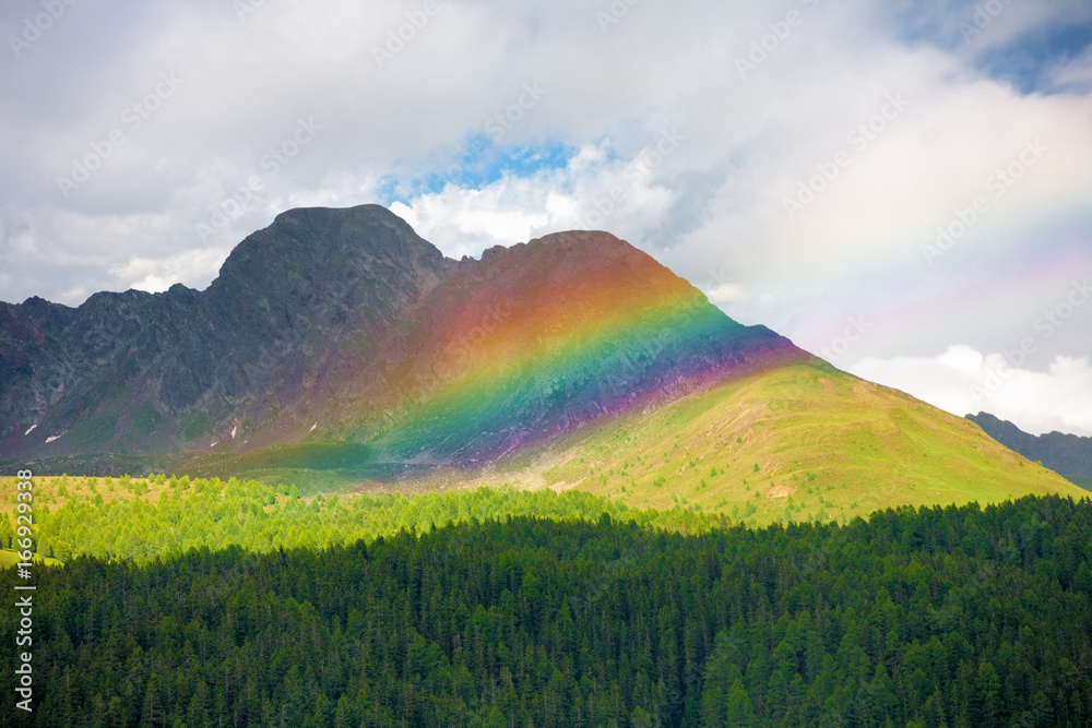 Beautiful rainbow among the peaks of the Dolomites Mountains, Italy