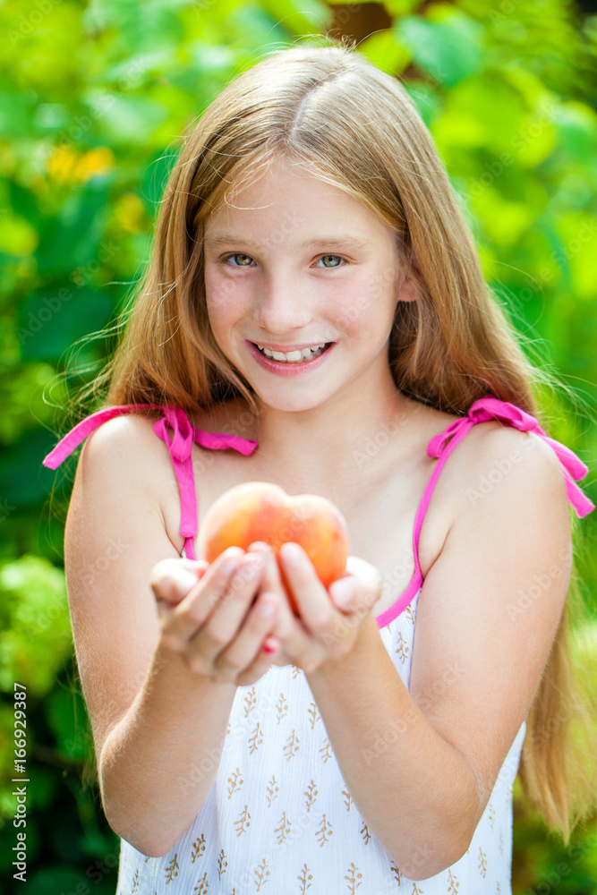 Portrait of a young blonde little girl with peach Portrait of a young blonde little girl with peach