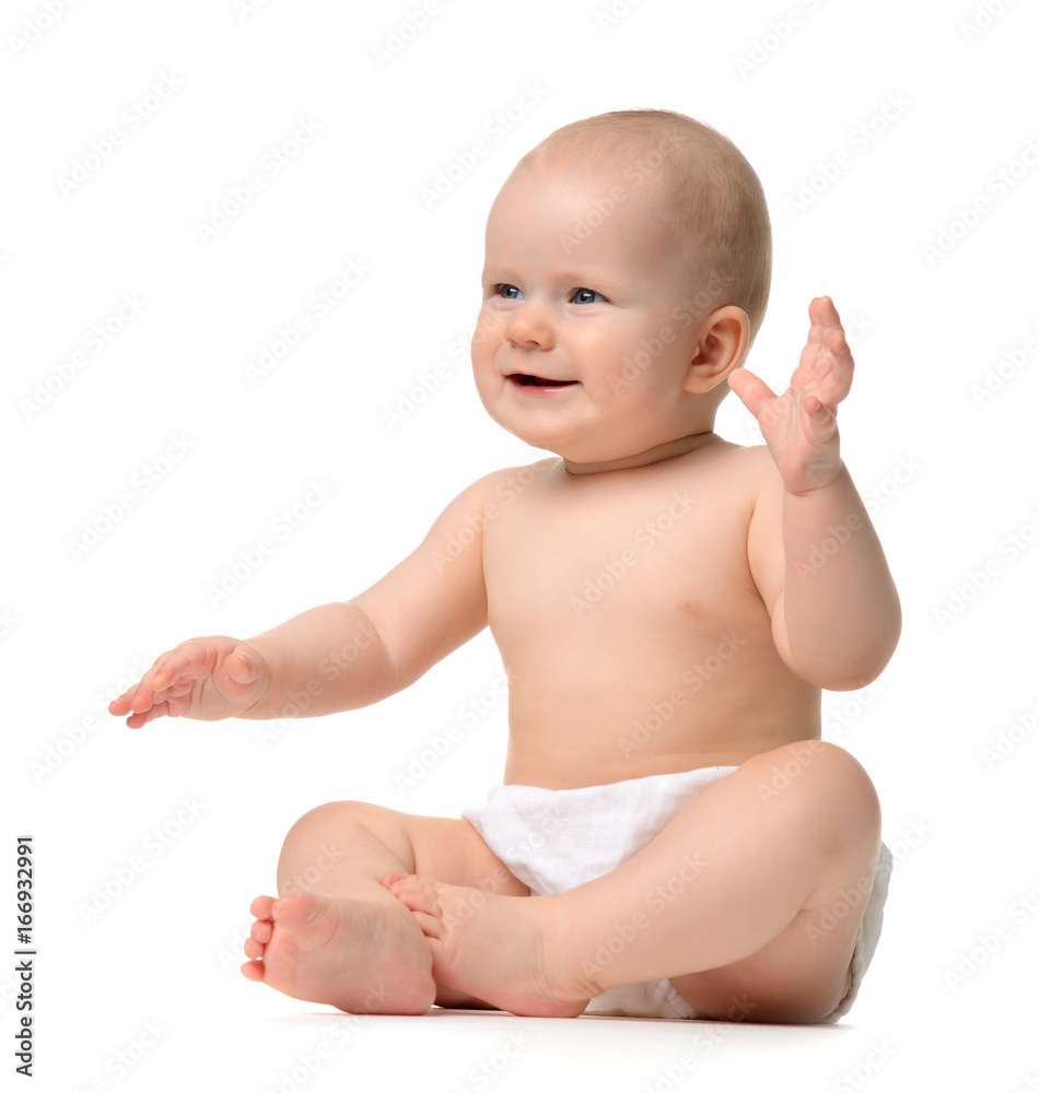 Infant child baby girl toddler sitting naked in diaper looking Infant child baby girl toddler sitting naked in diaper looking