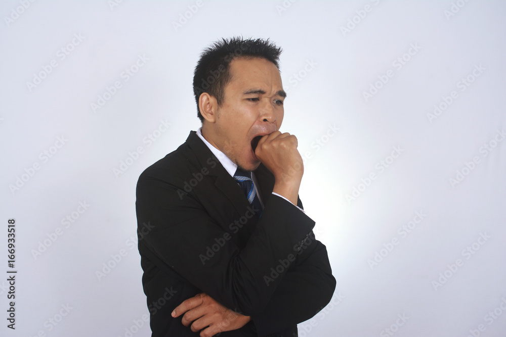 Photo image of a handsome attractive young Asian businessman yawning gesture isolated on white Photo image of a handsome attractive young Asian businessman yawning gesture isolated on white