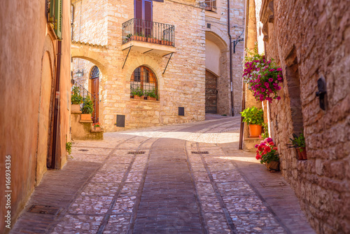 Fototapeta Naklejka Na Ścianę i Meble -  SPELLO, ITALY - MAY 27, 2017 - View of a typical alley of Spello, a medieval and beautiful town in Umbria.
