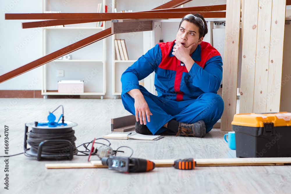 Young carpenter with notebook writing planning at construction r