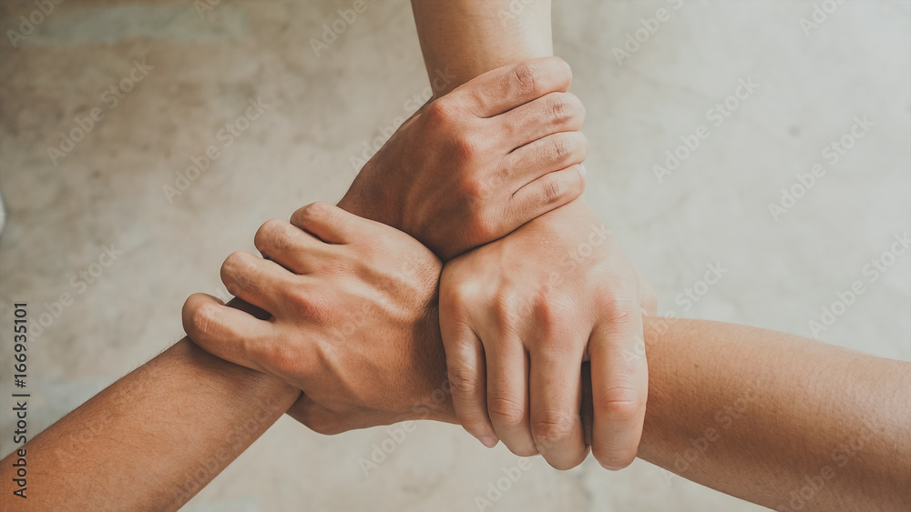 Three human join hands together, collaboration concept of business and education teamwork, soft focus and vintage color tone process - obrazy, fototapety, plakaty 