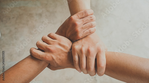 Three human join hands together, collaboration concept of business and education teamwork, soft focus and vintage color tone process