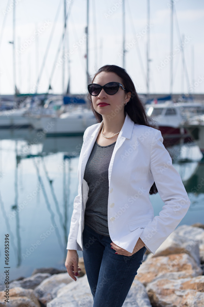 Woman dressed in nautical style in yacht marina Woman dressed in nautical style in yacht marina