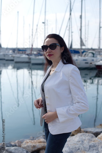 Woman dressed in nautical style in yacht marina