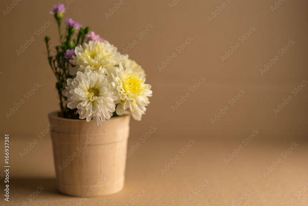 Colorful flowers in the wooden bucket