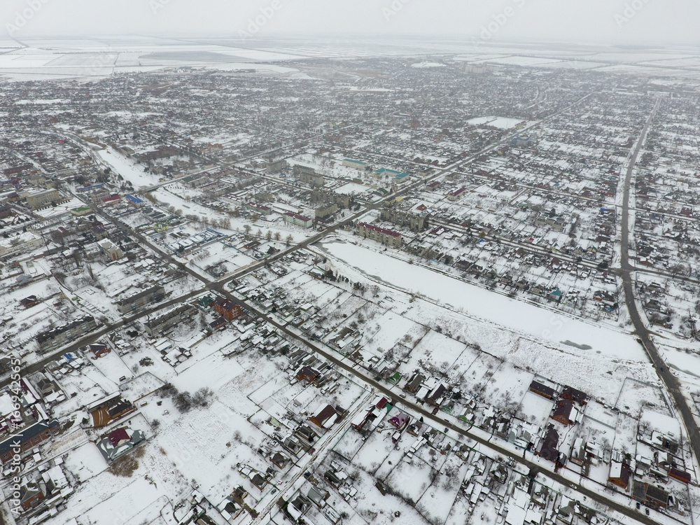 Winter view from the bird's eye view of the village. The streets are covered with snow