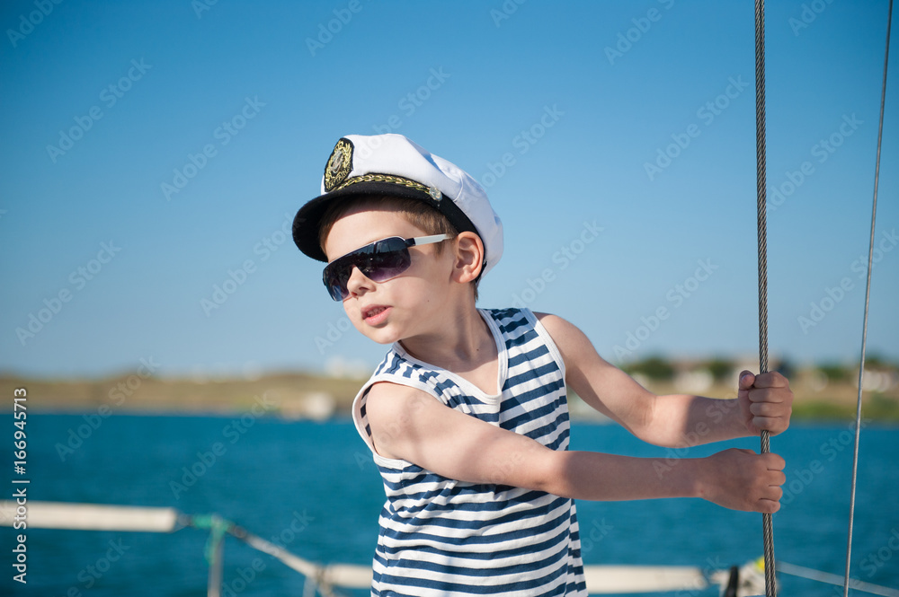 cute little captain aboard sea vessel